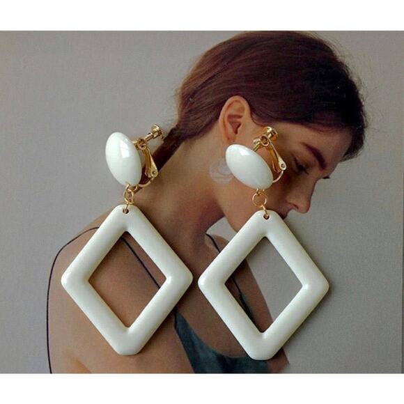 Clip on 2 1/2" gold and cream plastic dangle cutout earrings - Picture 3 of 4